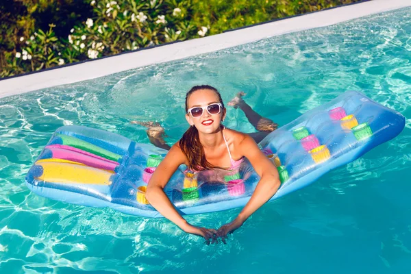Woman in bikini having fun at pool