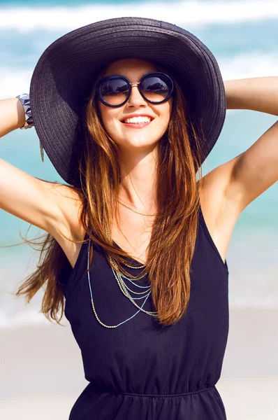 Woman wearing vintage hat and sunglasses