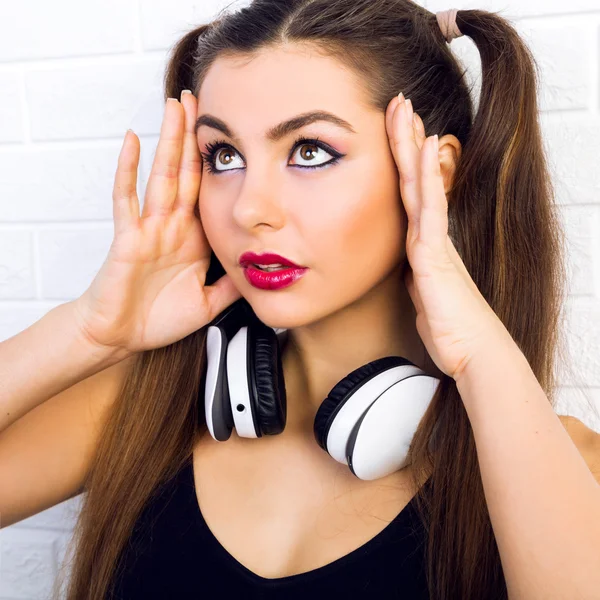 Teen girl with big white earphones
