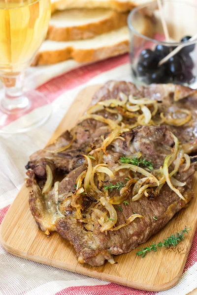 Fried pork chops with caramelized onions