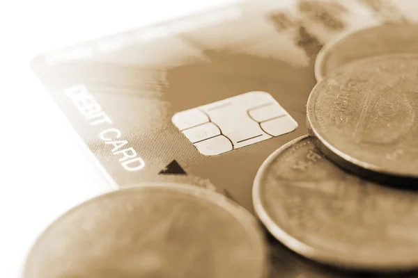 Close up chip card on debit card with coin
