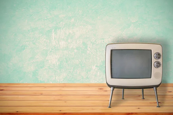 Old TV on wood table.