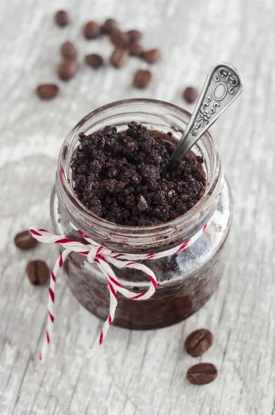 Coffee and cocoa (dark chocolate) homemade face and body scrub in a small glass jar