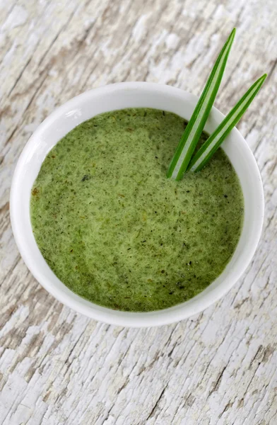 Organic herbal face and body mask (scrub) in a small white bowl