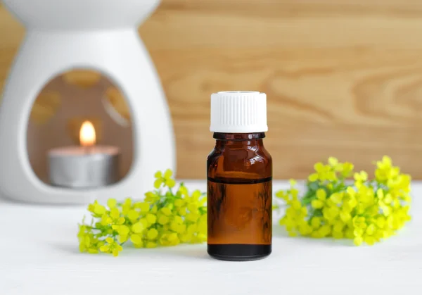 Small bottle of natural essential oil and lamp for aromatherapy