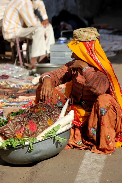 Old Indian woman selling vegetables