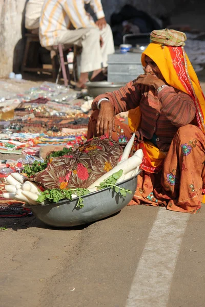 Old Indian woman selling vegetables