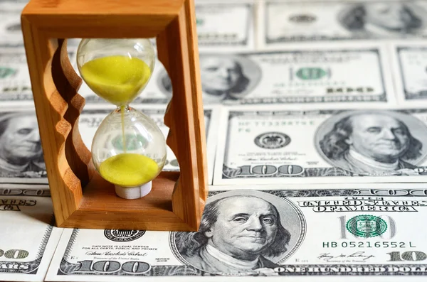Hourglass and dollars (time is money, capital, savings, profit -