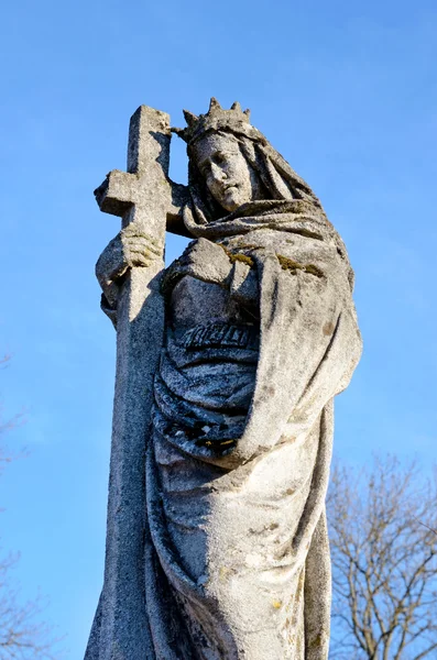 A stone statue of Jesus Christ on the grave in the old cemetery
