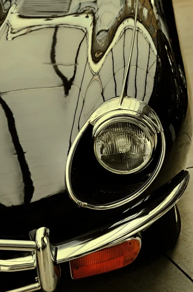 The hood and headlight stylish black retro car. Retro style.