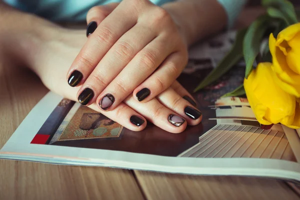 Gel nail manicures. Phone and the magazine on the table