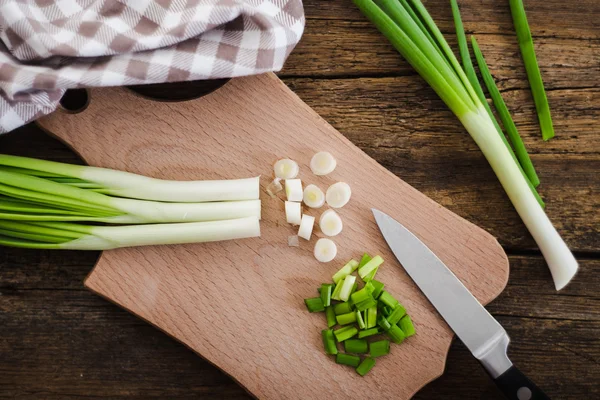 Green onions on wooden background. Cooking