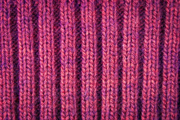 Knitted woolen background, red texture
