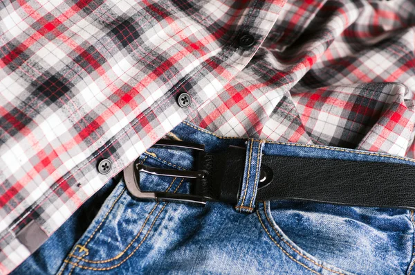 Plaid shirt and pair of jeans. Vintage stylized.