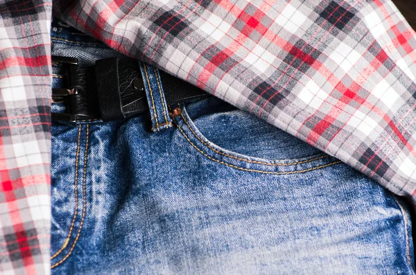 Plaid shirt and pair of jeans. Vintage stylized.