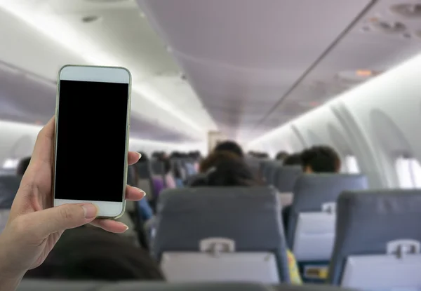Man use your phone in airplane blurred background