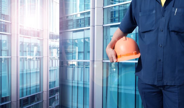 Engineer holding orange helmet for workers security