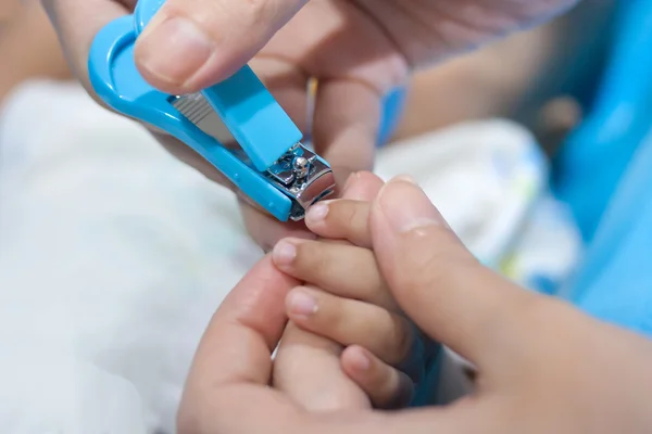 Mum cutting babies nails