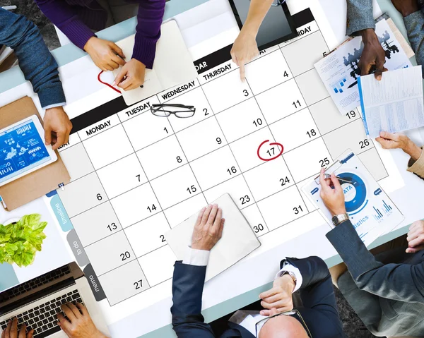 Business People Pointing on Calendar