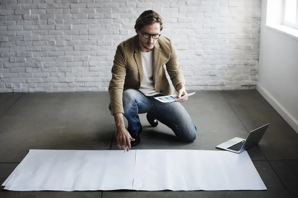 Businessman working with blank poster