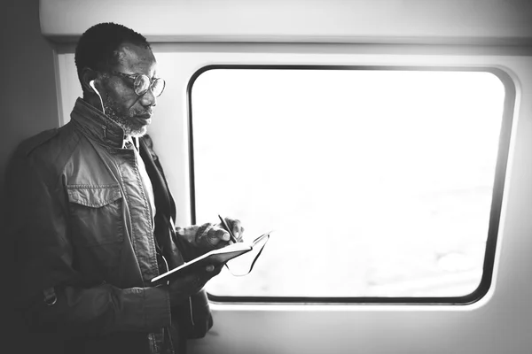 Businessman writing notes in train