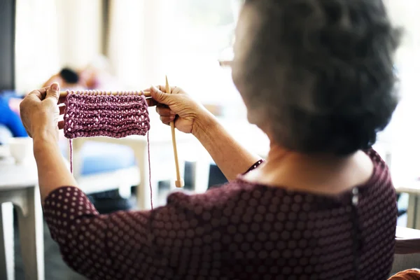 Elderly woman crocheting