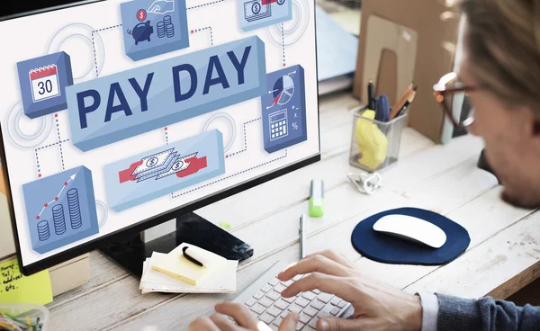 Businessman with pay day on monitor