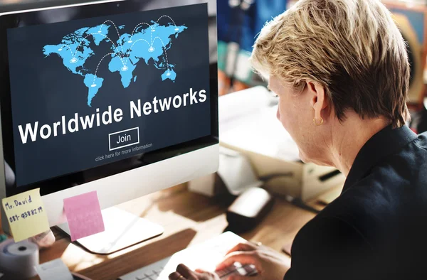 Businesswoman with worldwide networks on monitor