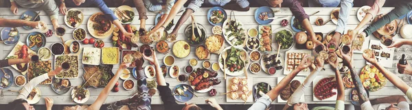 Friends eating for big table