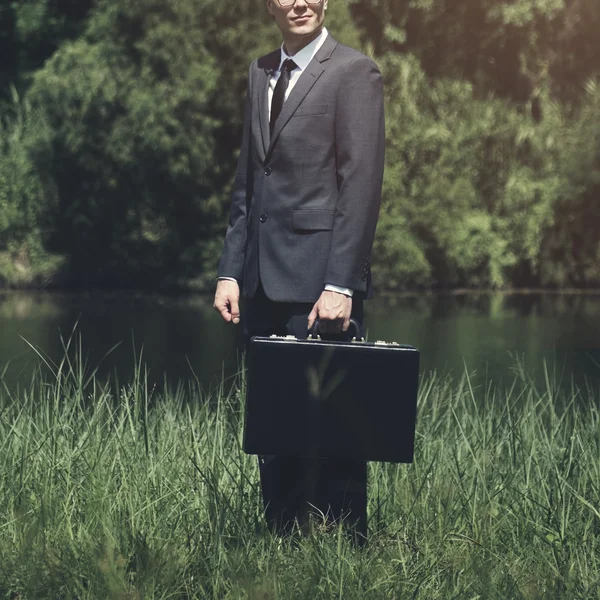 Businessman standing with briefcase outdoor