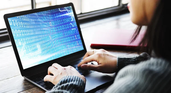 Woman working on laptop with binary code