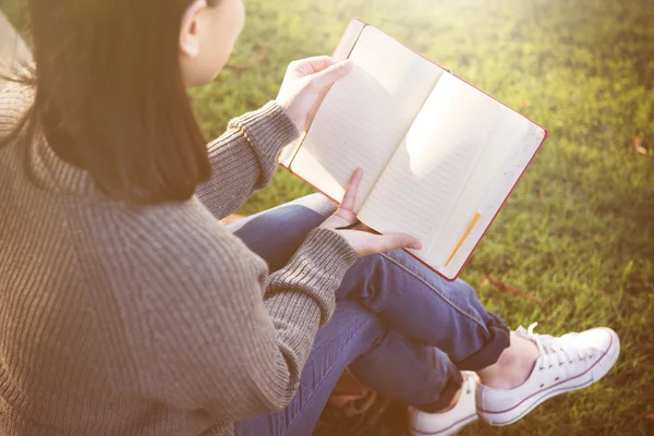 Woman looking in book