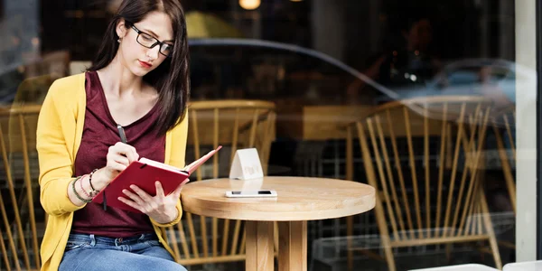 Woman Writing in Cafe