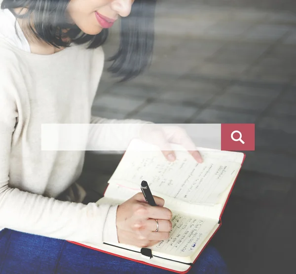 Woman writing in notebook with search bar