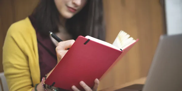 Woman Writing in Cafe