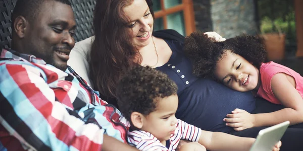 Portrait of happy family with digital tablet