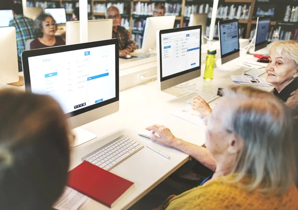 Senior people working with computers