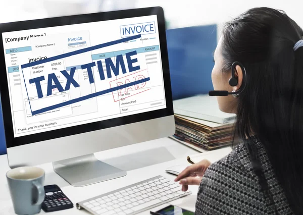 Businesswoman working on computer with Tax time