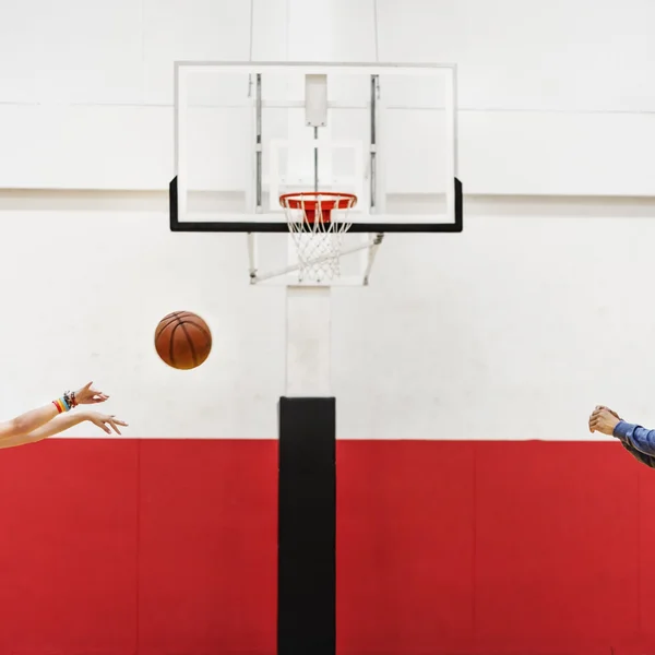 Sportsman teaching boy play Basketball