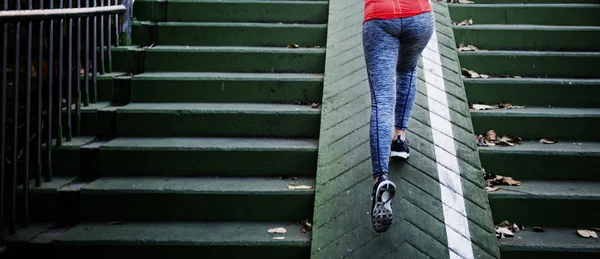 Sportswoman climb up stairs