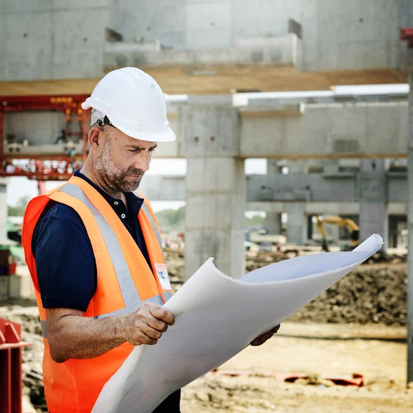 Construction Worker Looking at Building plan