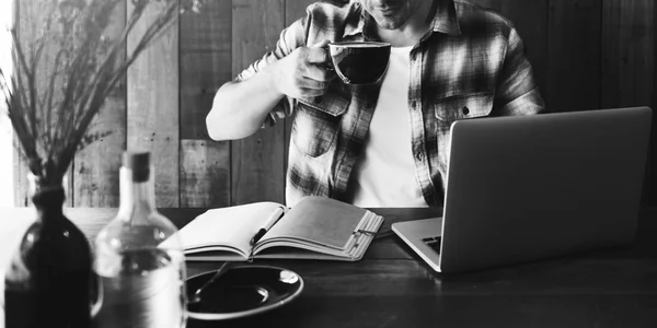 Man in coffee shop with laptop