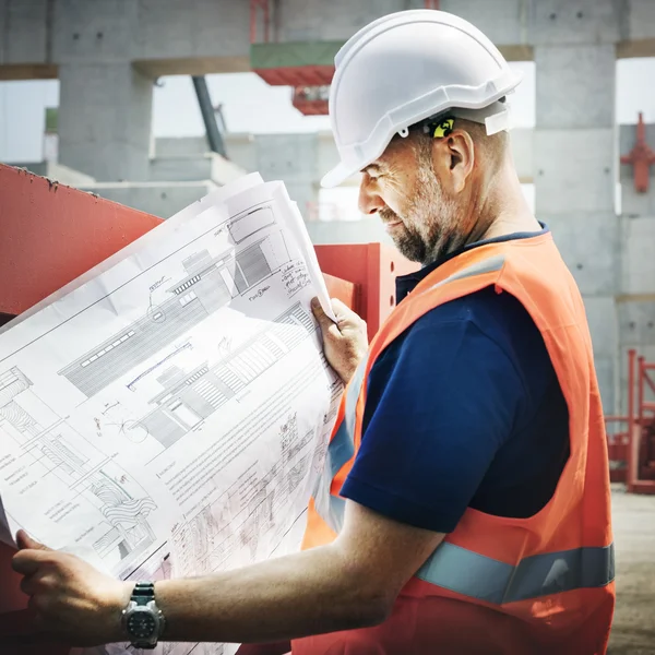 Construction Worker Looking at Building plan