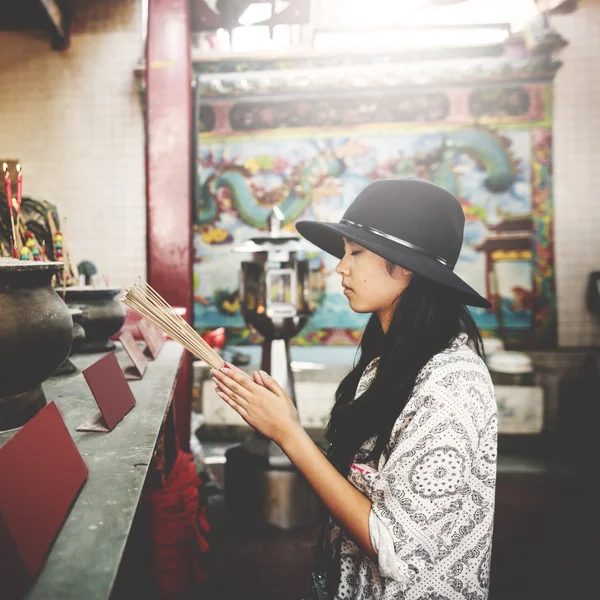 Asian woman in black hat