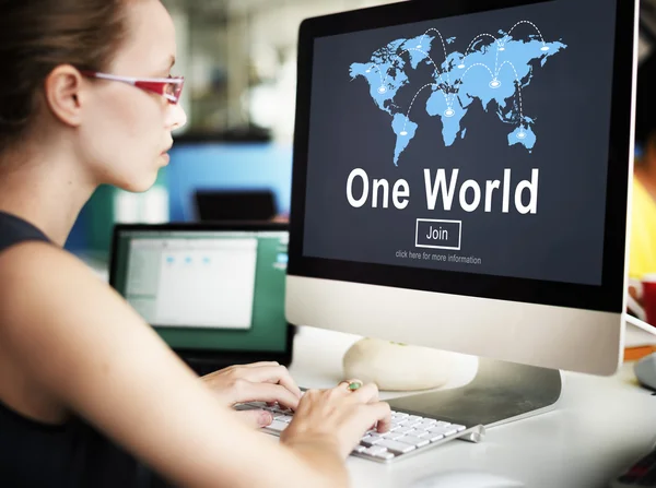 Businesswoman working on computer with one world
