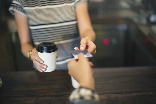 Woman buying coffee with credit card