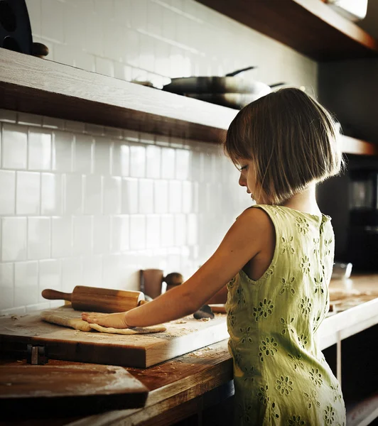Girl kneading dough for cookies