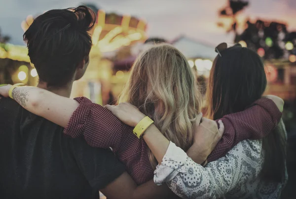 Friends hugging in Amusement Park