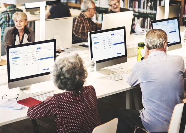 Senior people working with computers