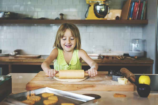 Girl kneading dough for cookies